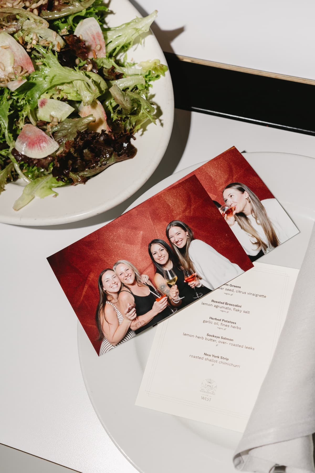 A candid dinner-table moment captured beside the MEMORI photo booth.